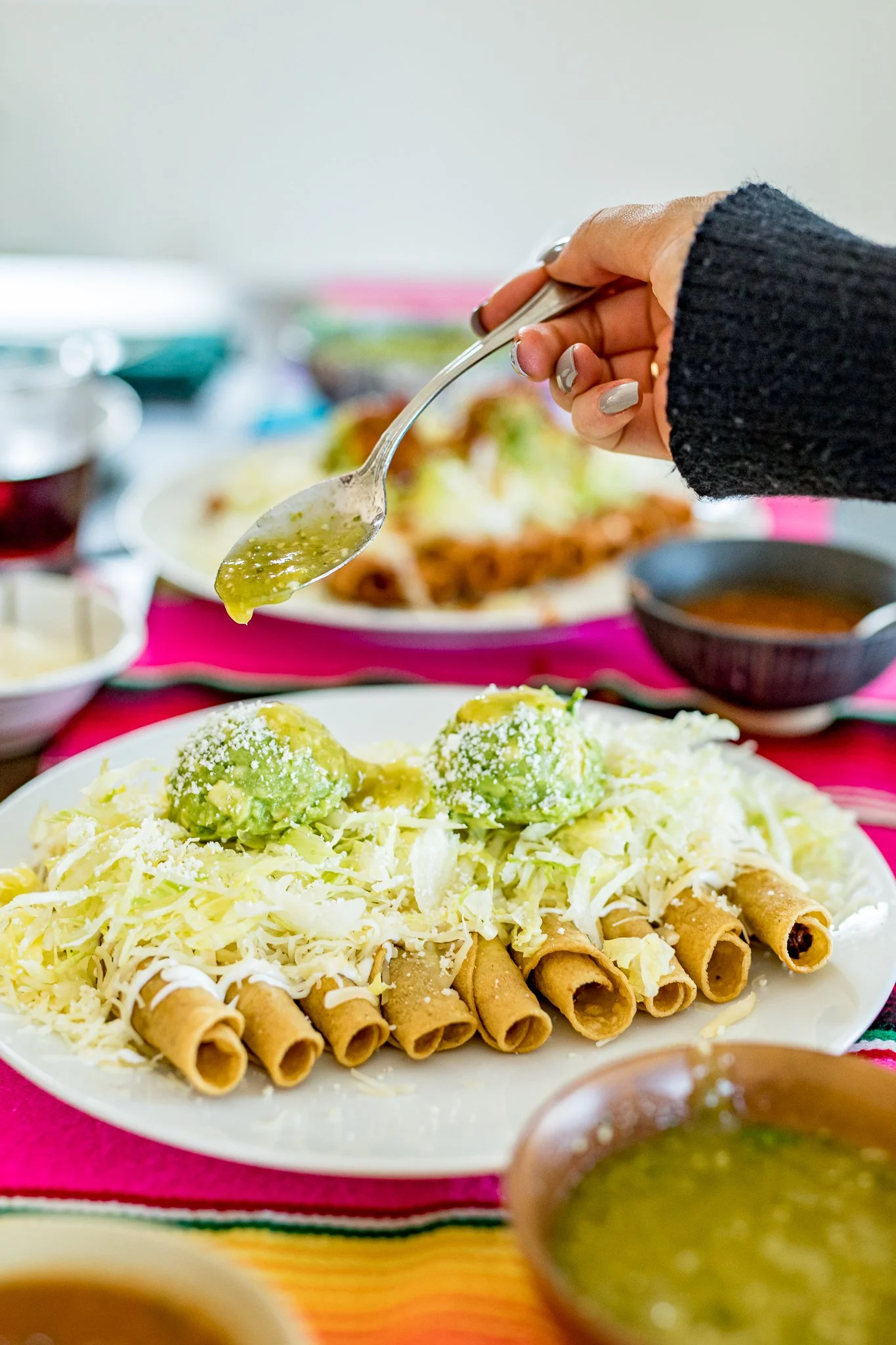 Rolled tacos with guacamole and salsa